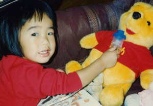 Toddler uses her brother's nebulizer on toy Pooh